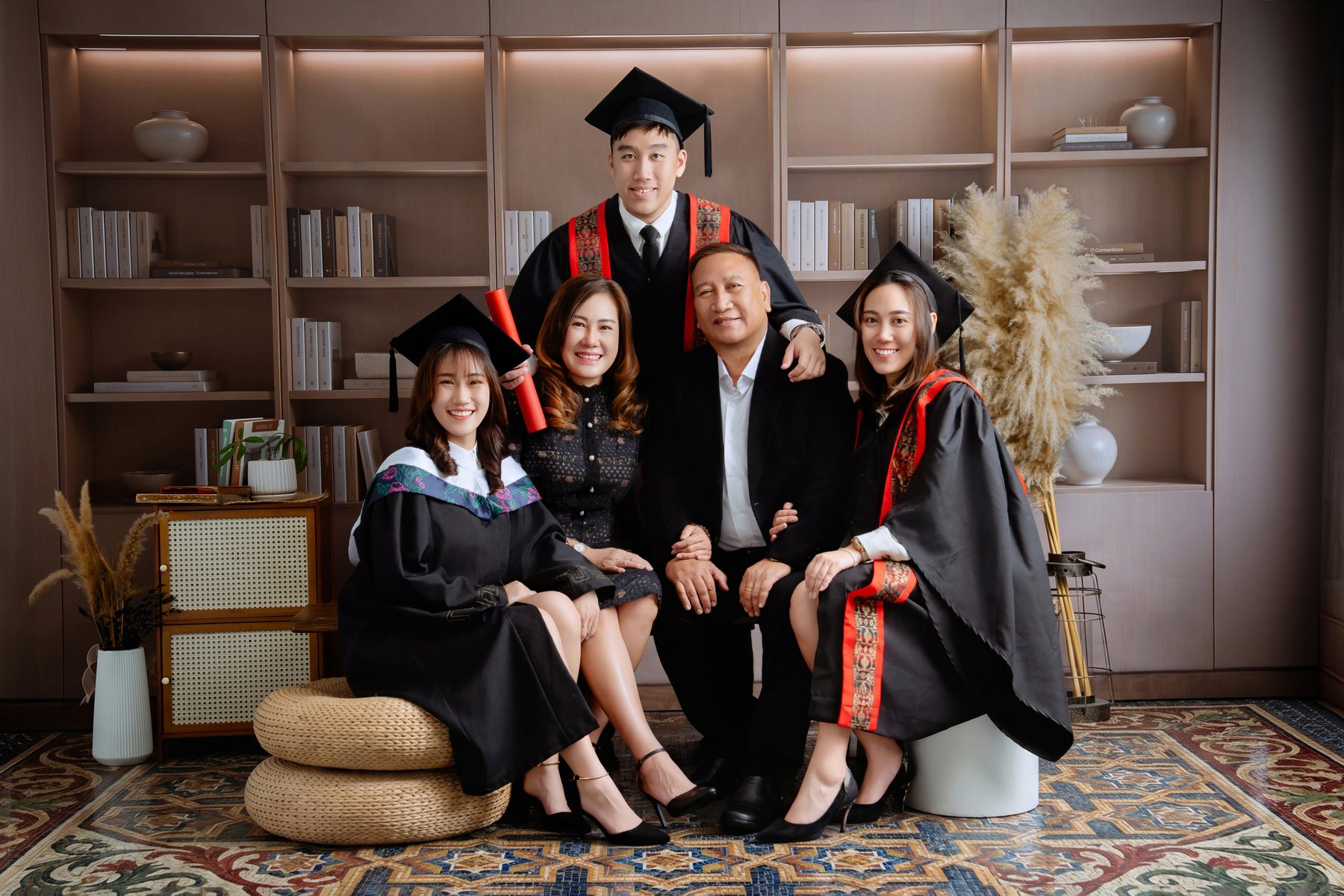 UMPSA graduate seated with family in Kuantan studio