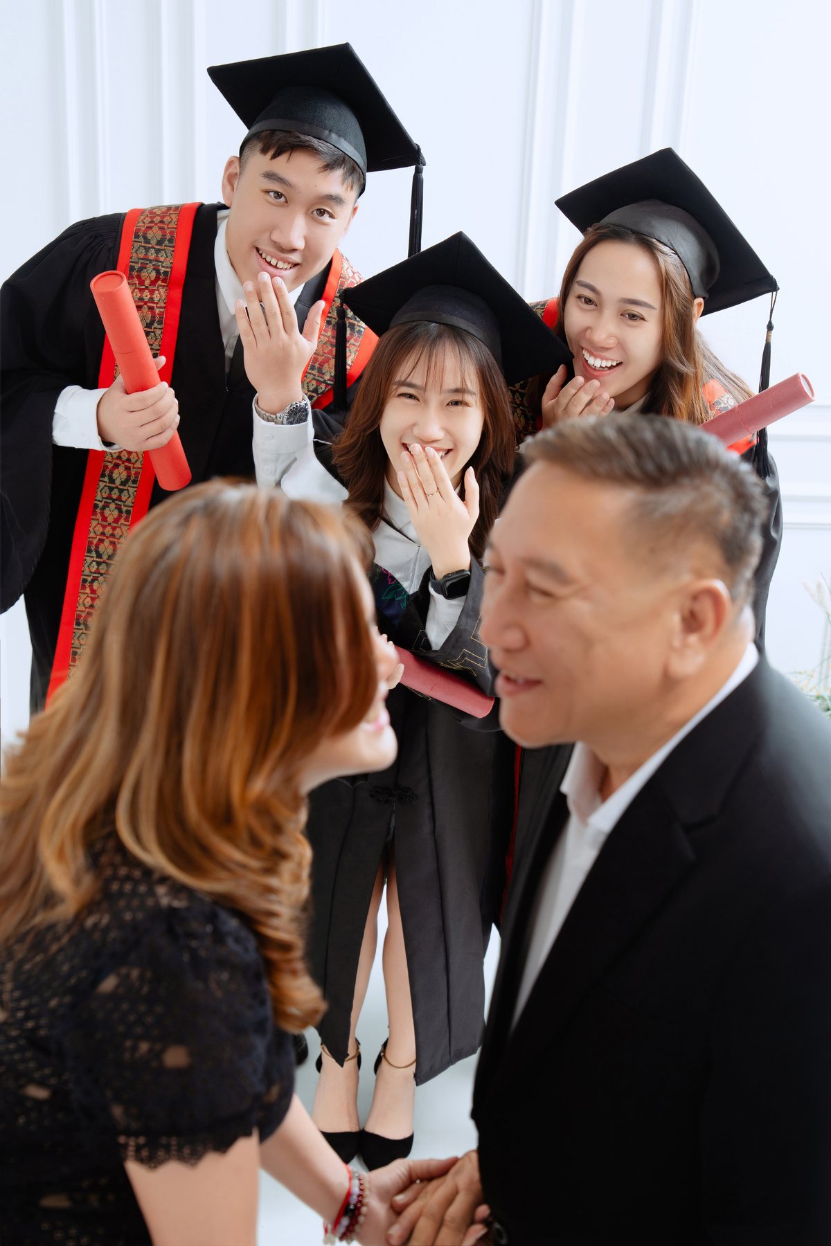Parents congratulating graduate during family photo session