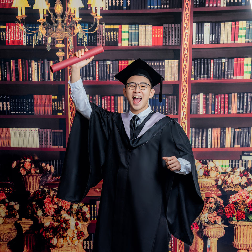Graduate portrait on library studio backdrop