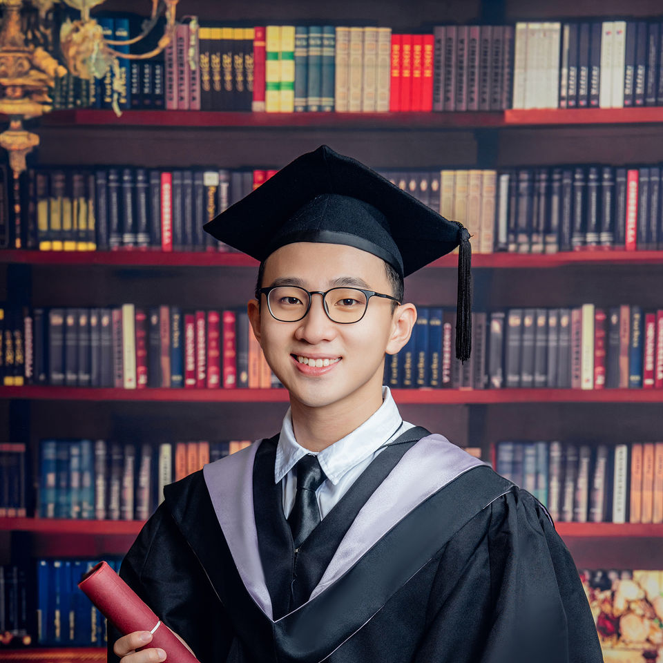 Close graduate portrait with diploma scroll