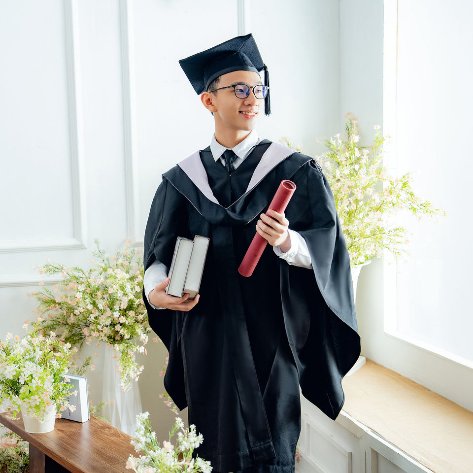 Bright studio convocation portrait with certificate