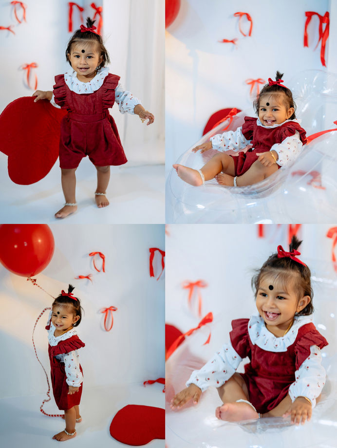 Baby birthday album photoshoot with red ribbon studio theme