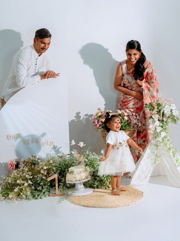 Baby milestone portrait with playful studio decor